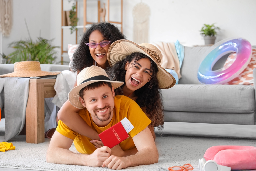 Happy family lying on floor holding passport