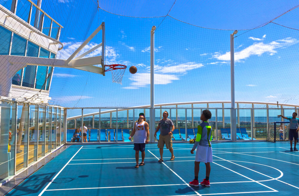People playing at upper deck inside cruise ship with mini basketball court